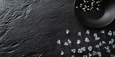Elegant black surface with scattered diamonds and delicate white flowers photo