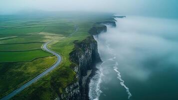 Aerial view of coastal cliffs and foggy ocean in scenic landscape photo