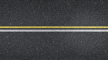 Close-up of asphalt road with yellow and white lines for transport concept photo