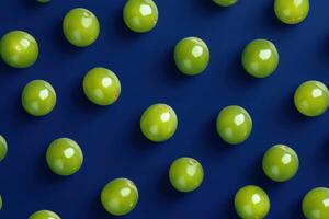 Pattern of fresh green grapes on a blue background for food and beverage concepts photo