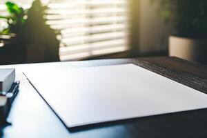 Blank paper on wooden desk in sunlit office setting, perfect for workspaces photo