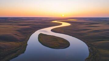 Serene sunset over meandering river and rolling hills landscape photo