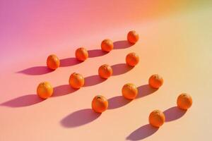 Geometric arrangement of oranges on colorful gradient background photo