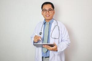 Smiling doctor using a tablet computer isolated on a grey background. photo