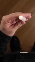 vertical pov man crosses himself and holding a small lit candle in his hand, first person video