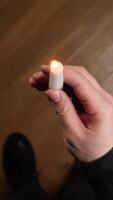 vertical pov Man holding a small lit candle in his hand video