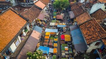 A vibrant market scene with colorful stalls and bustling activity in a traditional setting photo