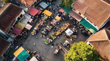 Aerial view of a vibrant market with colorful tents and bustling activity. photo