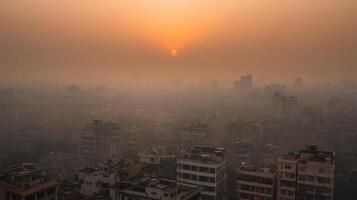 A hazy sunset over a sprawling urban landscape filled with buildings. photo