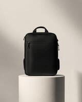 A sleek black backpack displayed on a pedestal, emphasizing design and functionality. photo