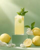 A refreshing lemon drink garnished with mint and surrounded by lemons and flowers. photo