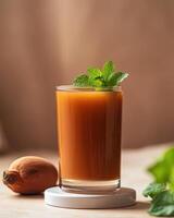 A refreshing drink garnished with mint, accompanied by a fruit on a wooden surface. photo