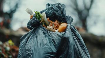 A black garbage bag filled with food waste and scraps, highlighting waste management issues. photo