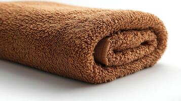 A brown towel folded on a white surface photo