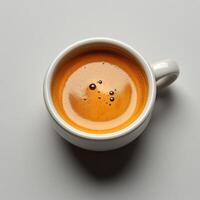 A cup of coffee with a small amount of liquid photo