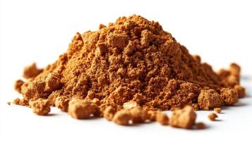 A pile of brown powder on a white background photo