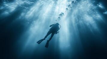 A person scuba diving in the ocean photo