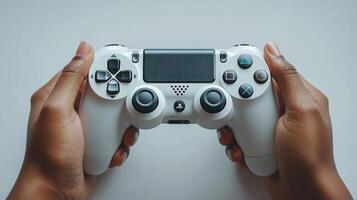 A person holding a white game controller photo