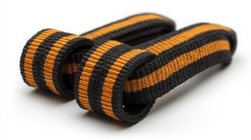 Black and Orange Striped Fabric Belt on a White Background photo