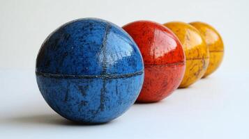 Four Colorful Spheres in a Row on a White Background photo