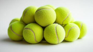 A Bright Pile of Yellow Tennis Balls on a Clean White Background photo