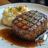 Flavorful Grilled Steak with Velvety Mashed Potatoes and Hearty Gravy photo