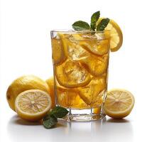 A glass of lemonade with mint leaves and lemons photo