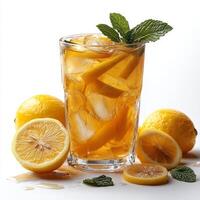 A glass of iced tea with lemon slices and mint leaves photo