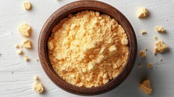 A bowl of yellow powder on a white table photo