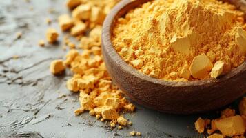 Fragrant Turmeric Powder in a Smooth Wooden Bowl photo