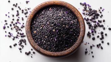 Black cumin seeds in a wooden bowl photo