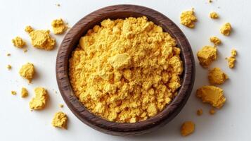 Tumeric powder in a wooden bowl photo