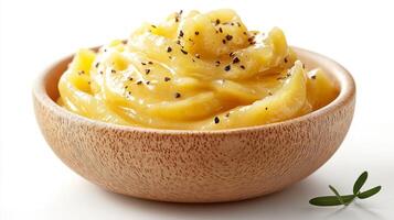 A Bowl of Creamy Yellow Mashed Potatoes with Black Pepper photo