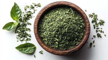 Dried Basil in a Wooden Bowl with Fresh Basil Leaves photo