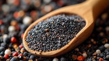 Black sesame seeds in a wooden spoon photo