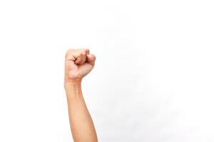 Close-up of a man's arm raised with a clenched fist on white background photo