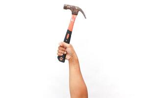 Hand gripping a weathered hammer, symbolizing construction and craftsmanship photo
