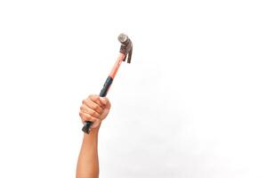 Conceptual handyman holding up hammer with nail ready to be hammered in photo