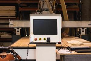 Computer numerical control of machine in workshop photo