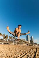 Strong man jumping high during outdoor workout photo