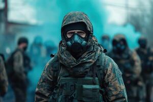 A man in a gas mask and camouflage gear is standing in front of a group of people photo