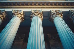 Three columns with white pillars in front of a building photo