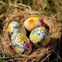 Three painted eggs in a nest with grass photo