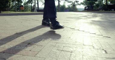A person strolls along a scenic path, casting clear shadows while enjoying the fresh air video