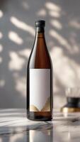 Elegant sake bottle with blank label and delicate golden accents, perfect for premium product branding, set on marble surface. photo