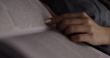 Focused Reading A Hand Holding Pages of a Book, Engaging, Learning, and Exploring Ideas video