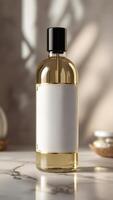 Elegant glass bottle of golden liquid with a black cap and blank label, evoking luxury and sophistication in a natural setting. photo
