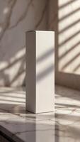 Elevated Packaging. A simple, elegant box stands against a backdrop of marble and light, conveying sophistication and quality. Timeless design. photo