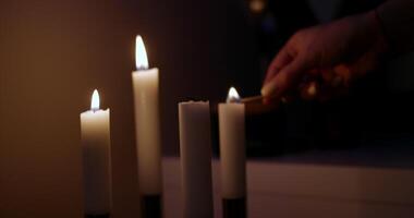 Creating a serene atmosphere by lighting candles during the tranquil nighttime hours video
