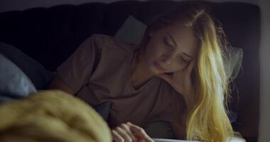 A contemplative woman relaxes on her bed, surrounded by soft lighting, creating a calm ambiance video